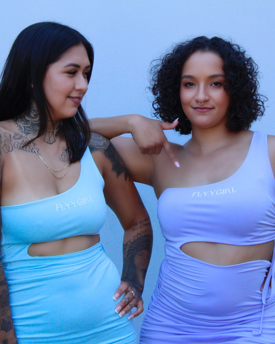 Close-up of FLYYGIRL logo detail on dress