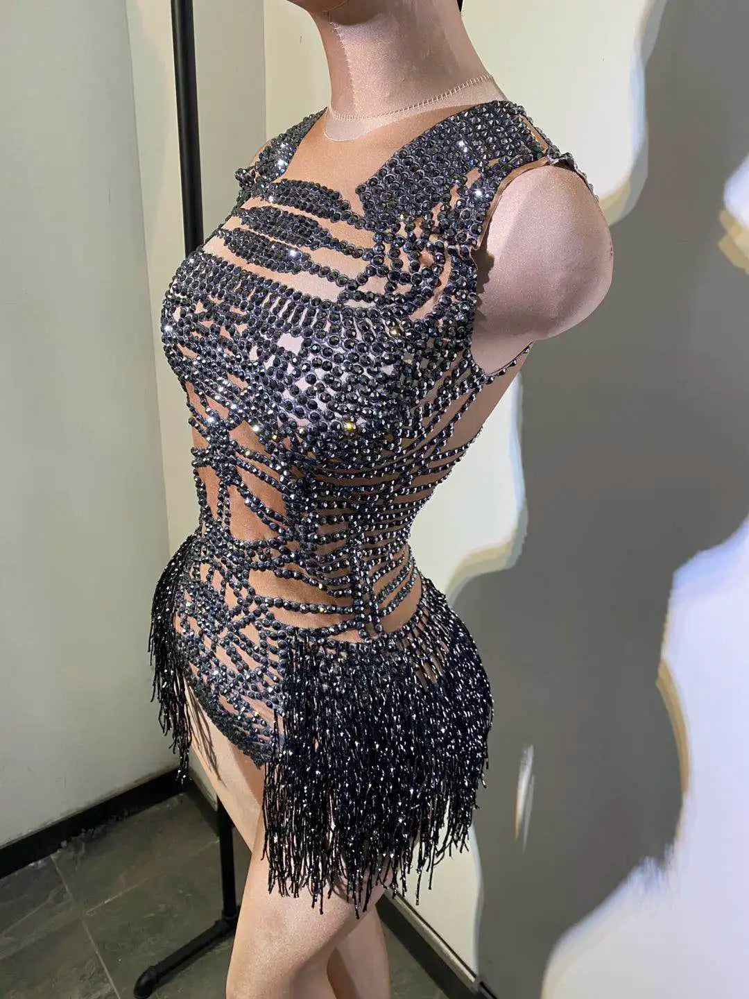 Side view of sleeveless nude mesh dancer bodysuit with sparkle