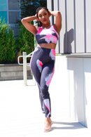Woman in pink tie-dye two-piece lounge set with crop top and pants