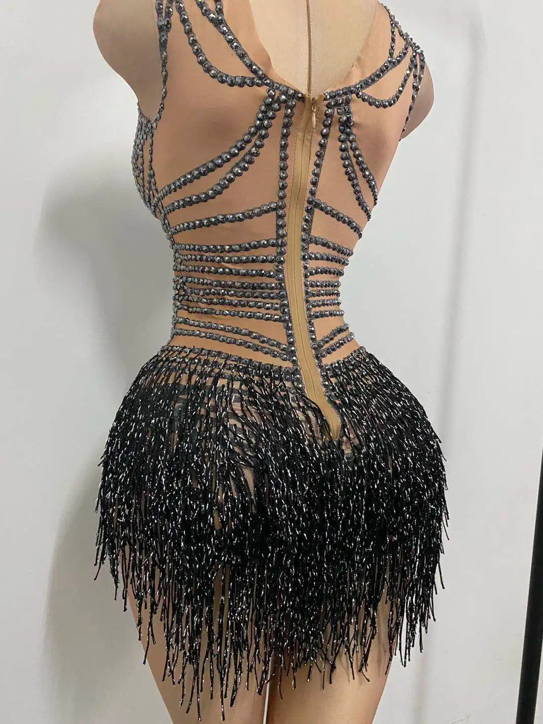Close-up of crystal tassel detailing on bodysuit